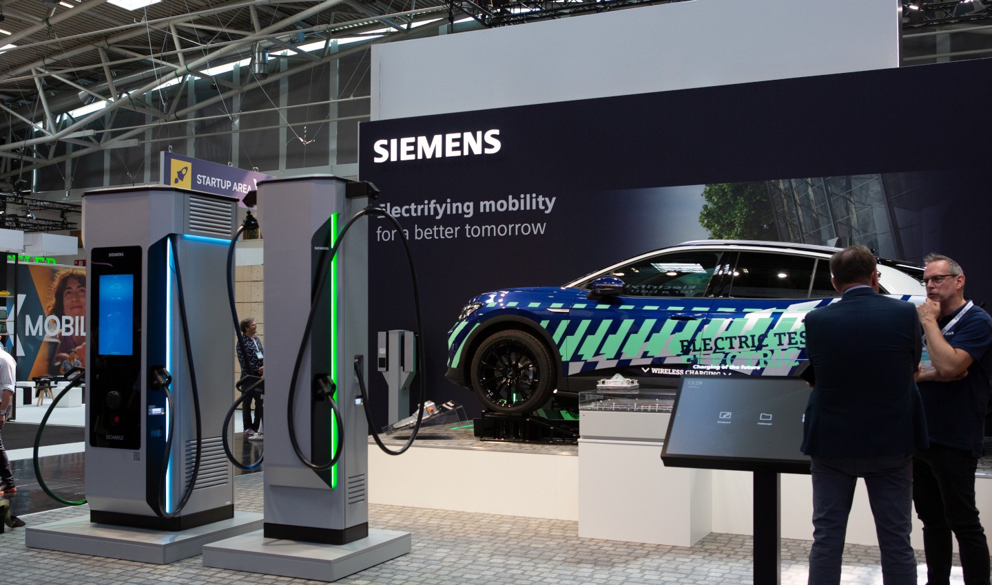 A picture of Siemens stand, showing off its EV charging hardware and vehicle.